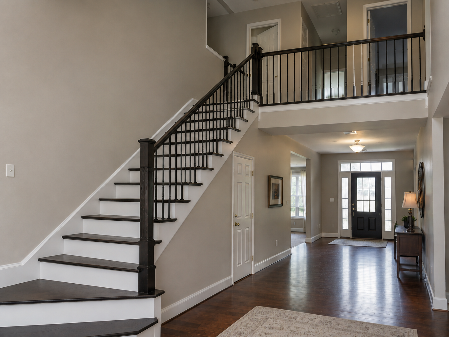 After staircase renovation with dark stained treads and black balusters in Ballantyne Charlotte NC