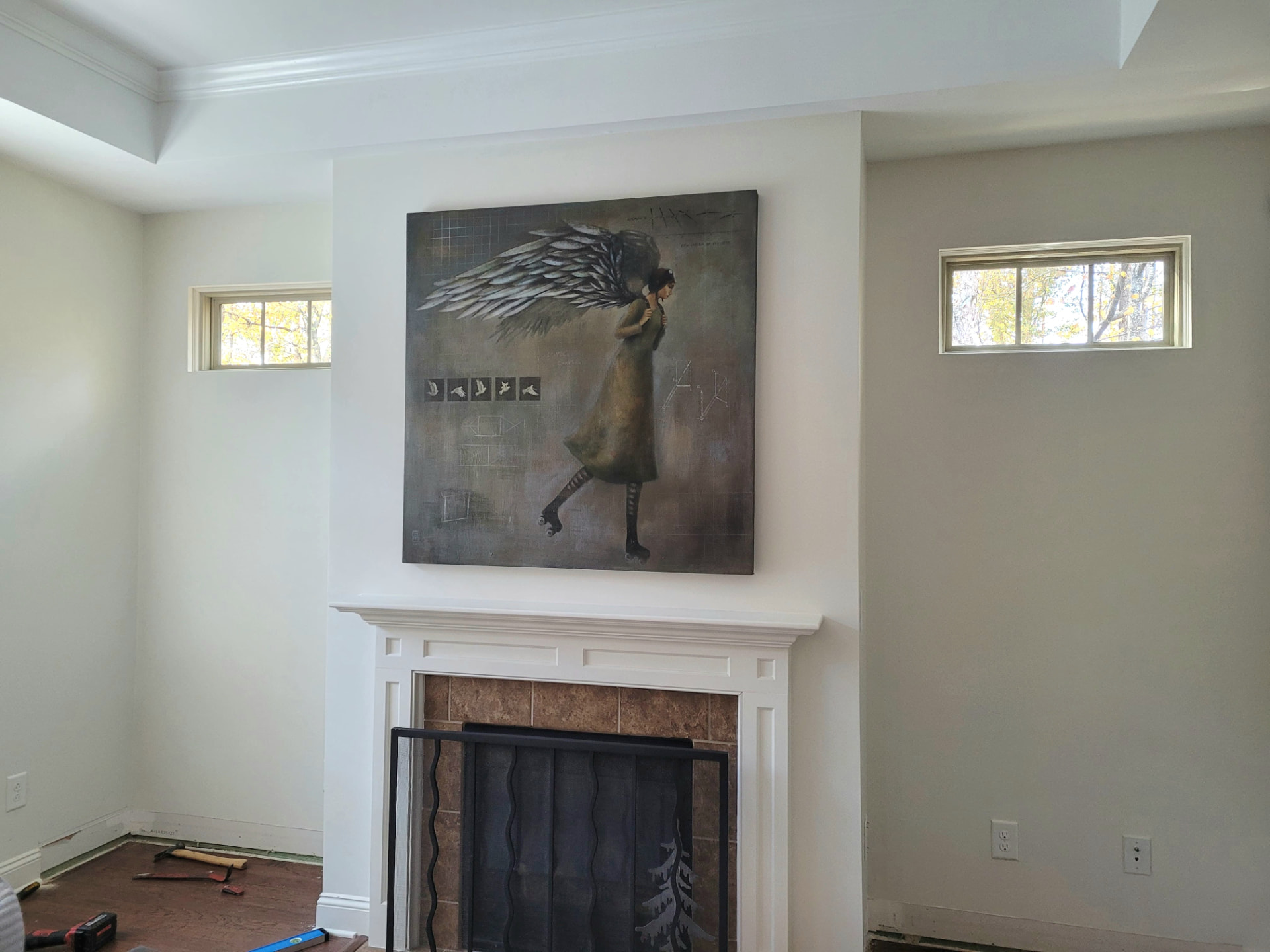 Before photo of a plain fireplace wall in South Charlotte with bare walls and no built-in shelving