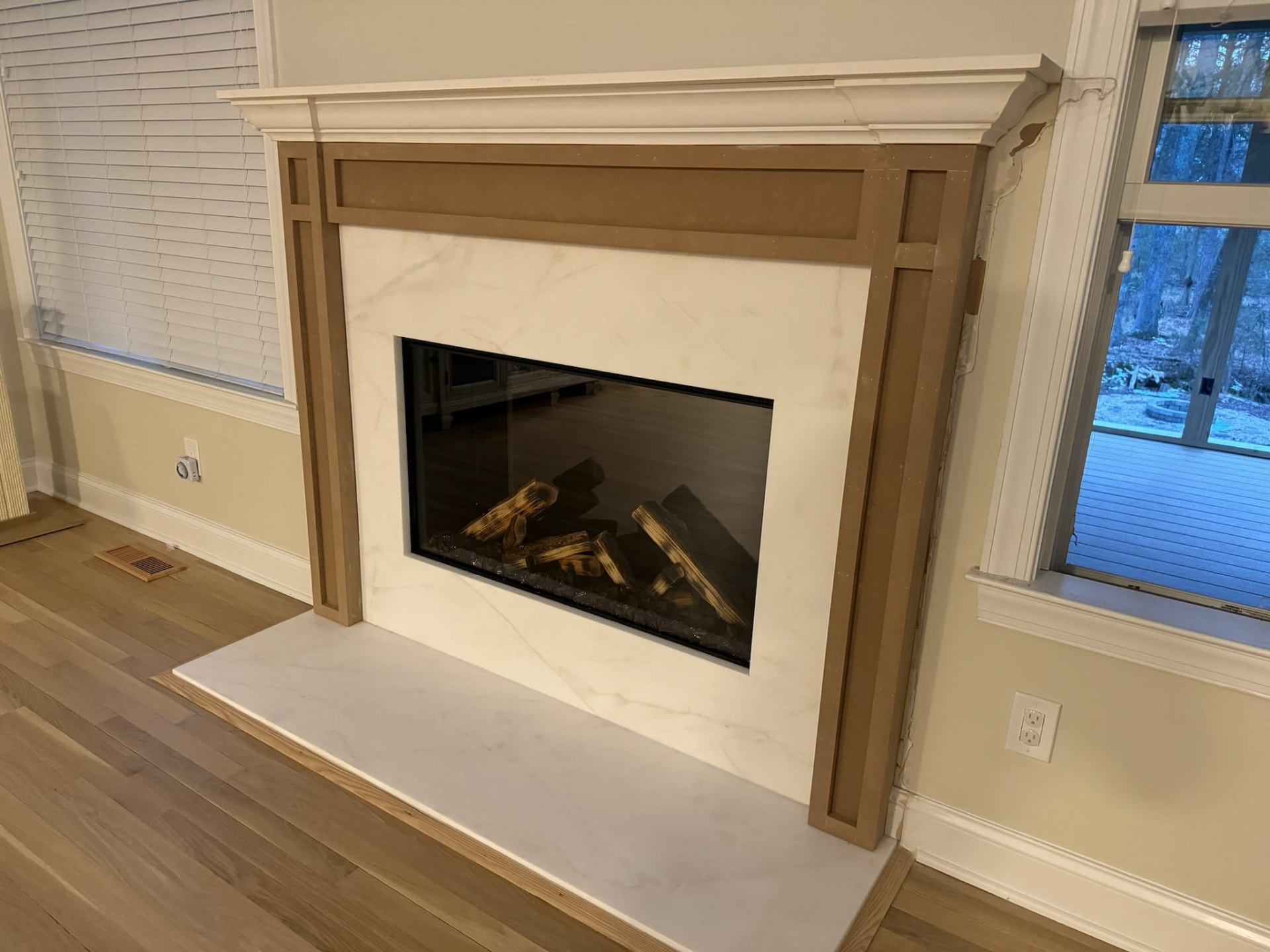 Before photo of an unfinished fireplace mantel and surround in Ballantyne awaiting trim and paint