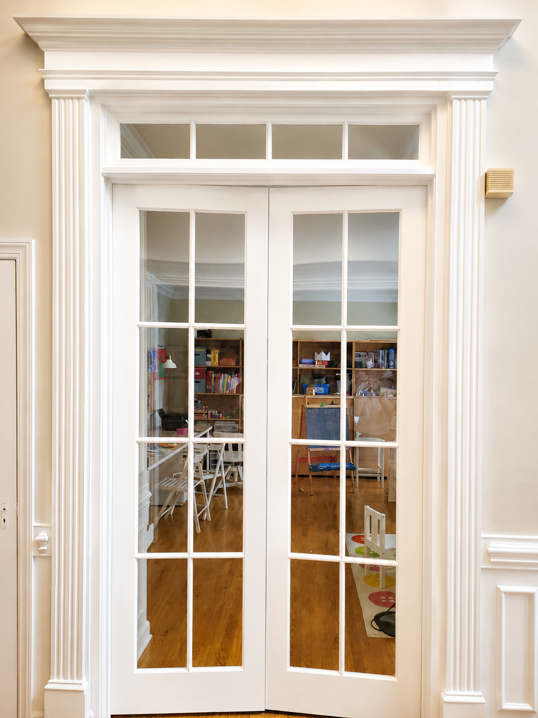 After interior painting photo of crisp white French doors, casings, and millwork in Marvin NC