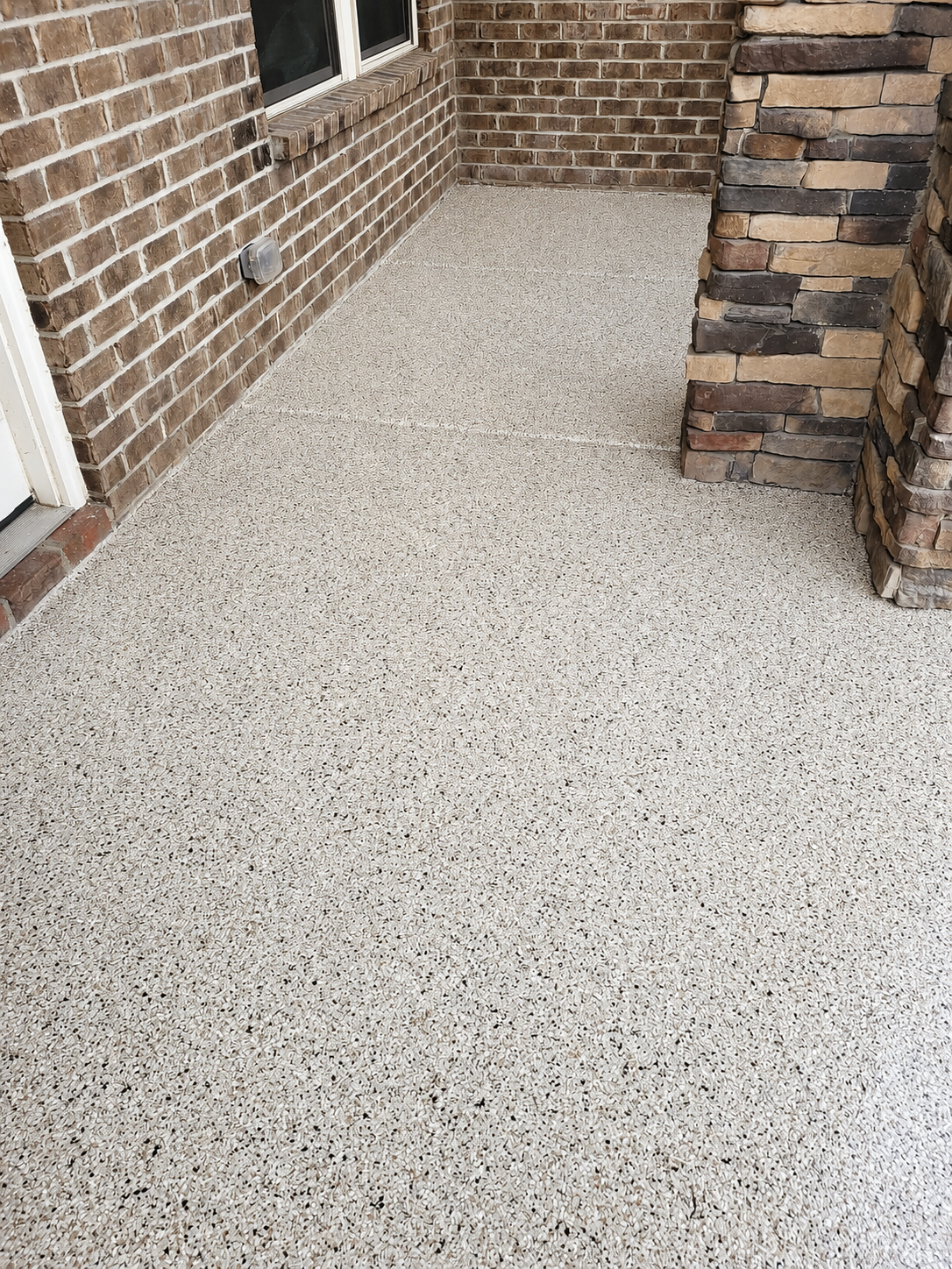 After photo of decorative concrete porch flooring upgrade in Ballantyne Charlotte with custom finish