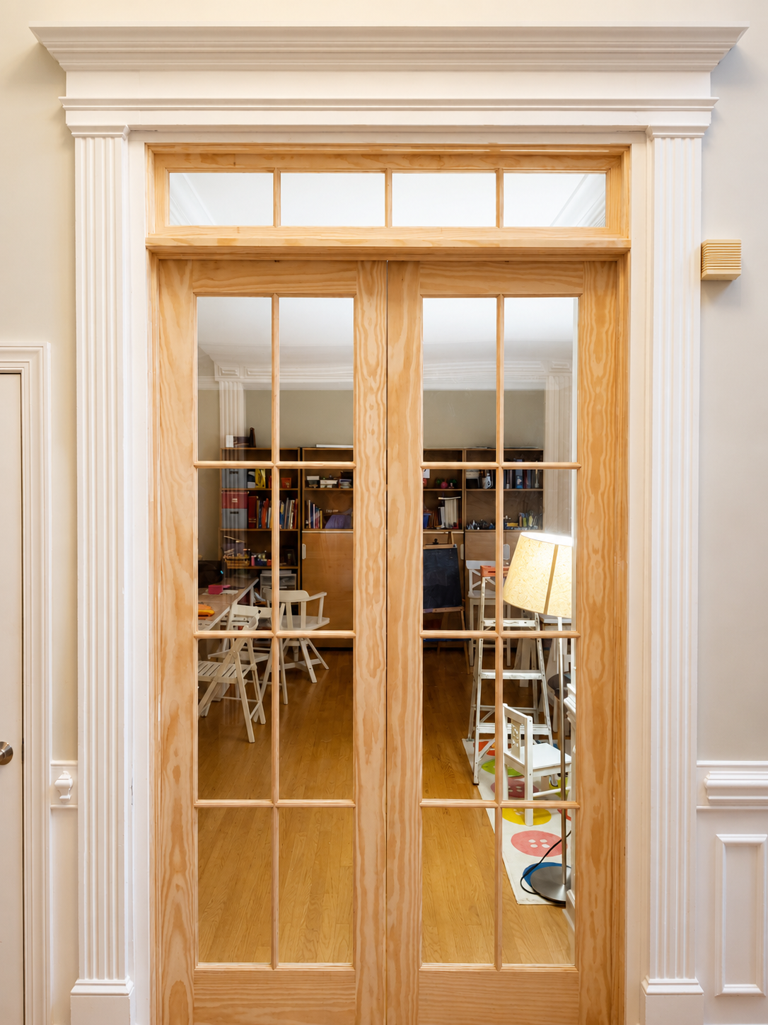 Before interior painting photo of unfinished pine French doors and trim in a Marvin NC home