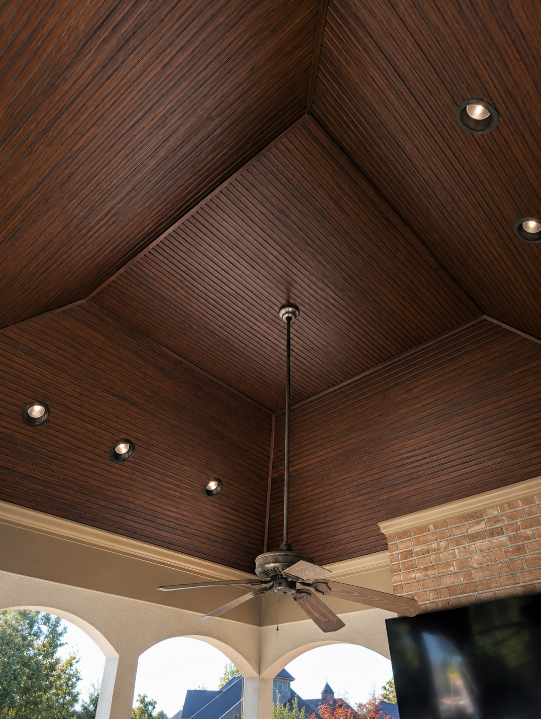 Before image of dark stained wood tray porch ceiling with recessed lighting and ceiling fan in South Charlotte NC