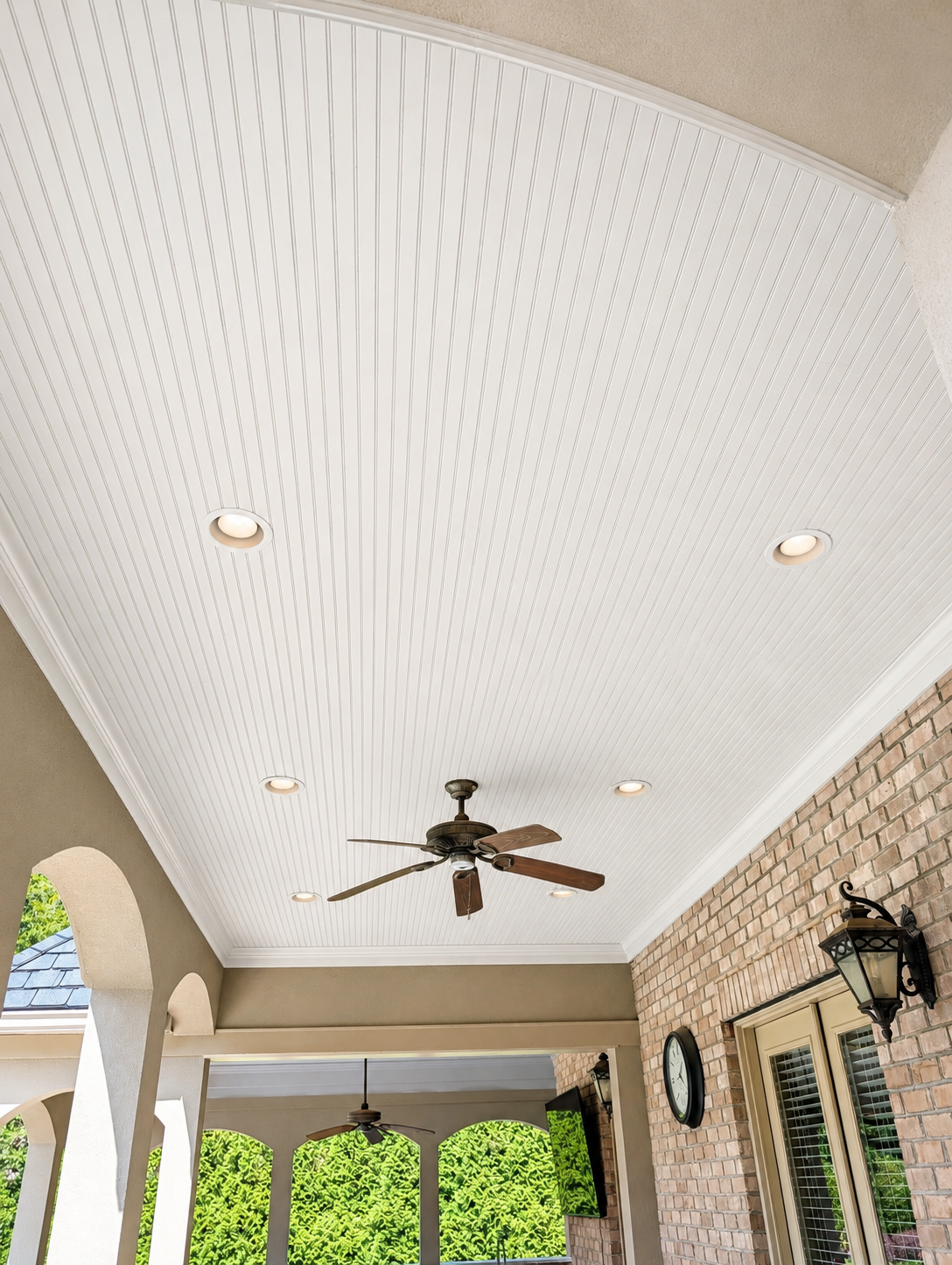 After image of white painted beadboard vaulted porch ceiling with recessed lights and ceiling fan in Charlotte NC