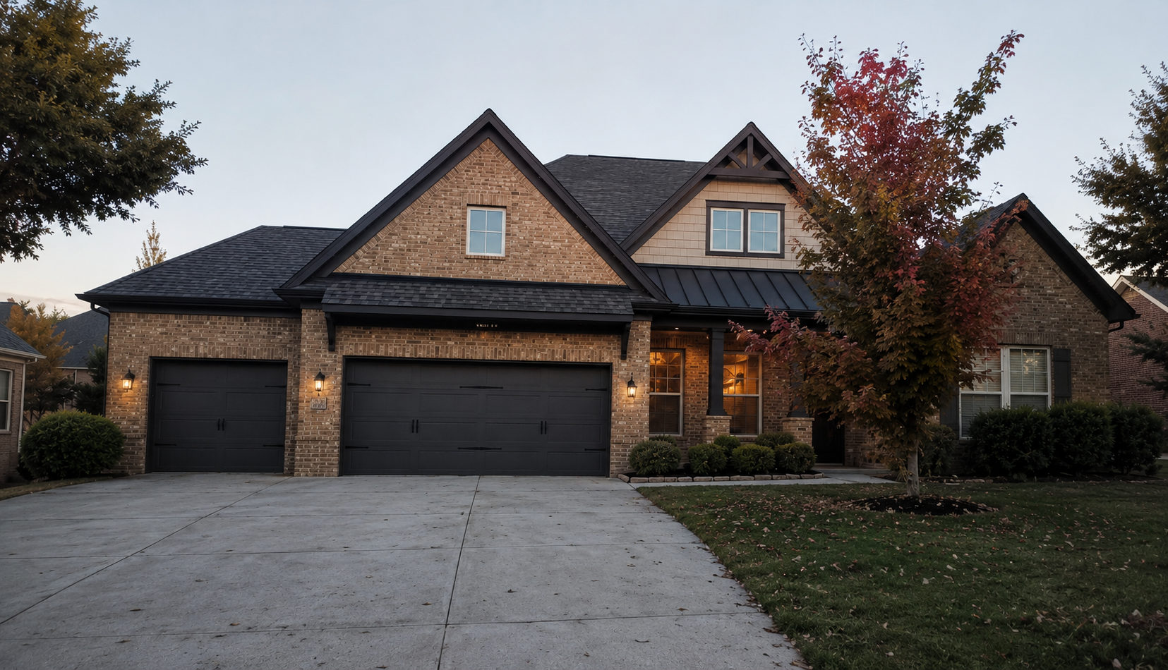 Before exterior painting photo of Charlotte brick home with lighter garage doors and trim details