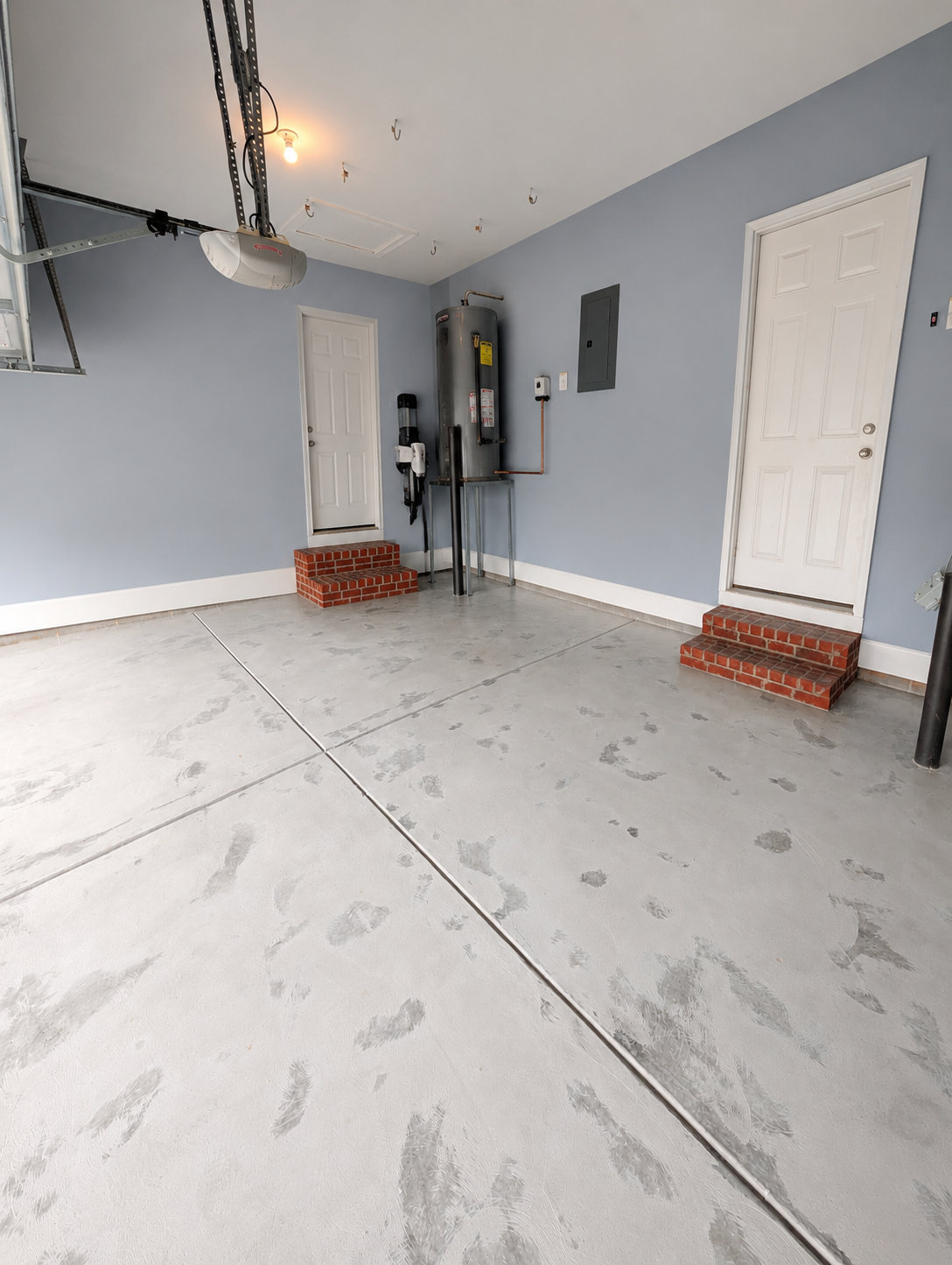 Before photo of stained concrete garage floor in Waxhaw NC prior to epoxy coating installation